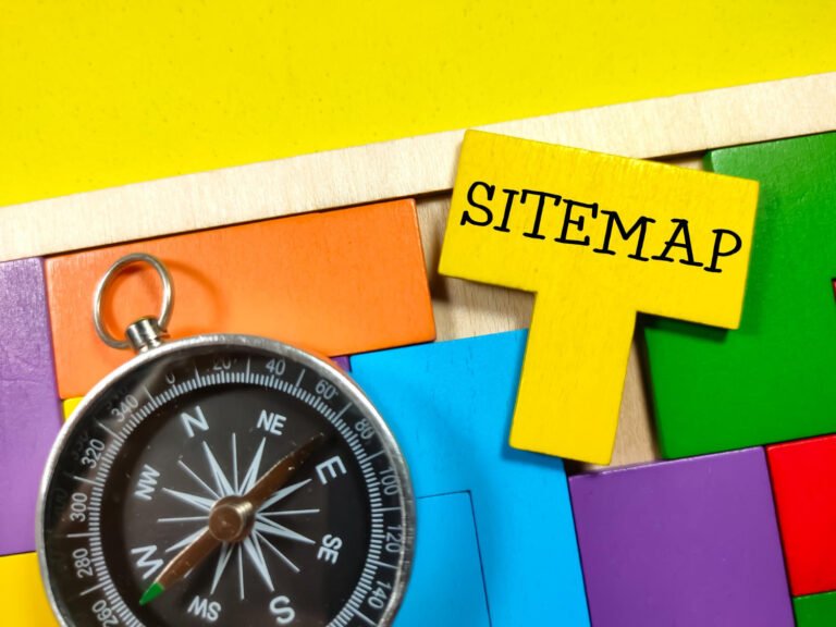 Compass next to a board with 'Sitemap' written on it, representing a guide for navigating a website.