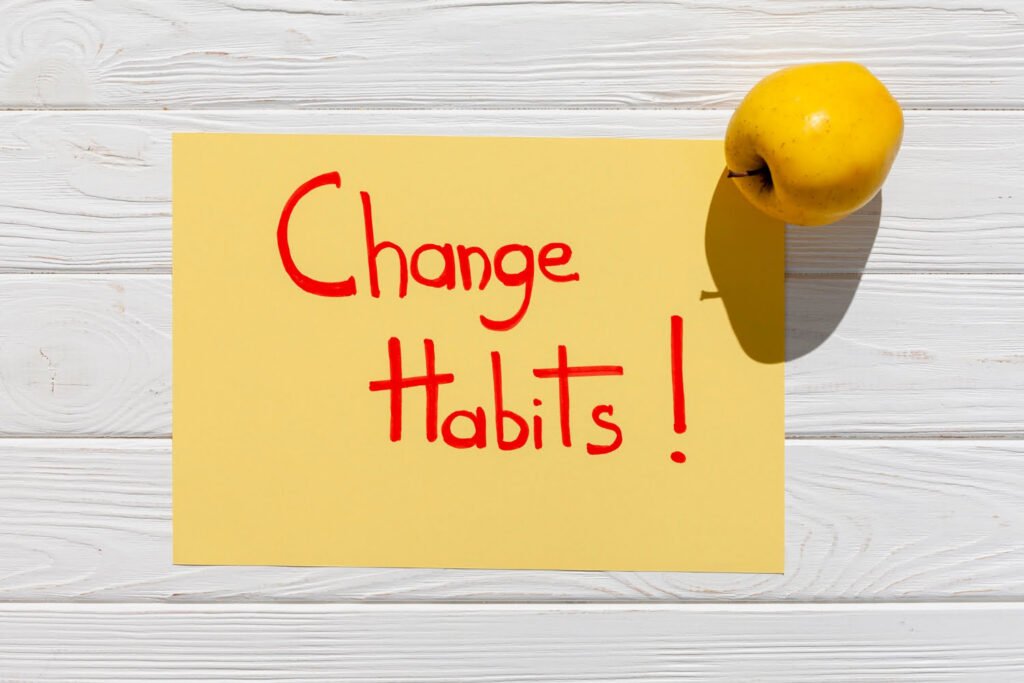 Message about changing habits with an apple in the foreground, symbolising healthy lifestyle changes.