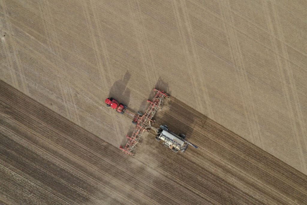 Fertiliser machine operating on a modern farm, resembling a Moon-like field, illustrating the impact of modern agriculture on soil nutrients.